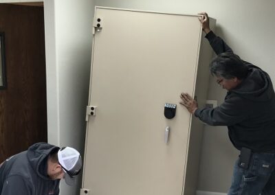 Technicians installing cash safe